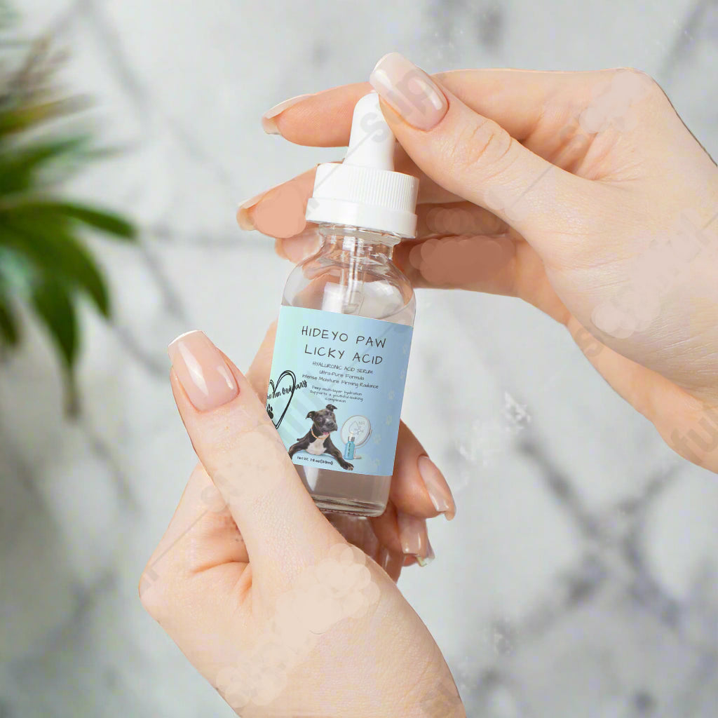 Hand holding a small bottle labeled 'HIDEYO PAW LICKY ACID' against a light background.